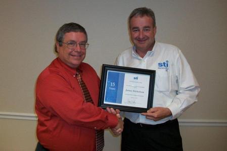 David Raby presents James Nicholson with 15-year anniversary certificate